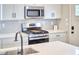 Modern kitchen with stainless steel appliances, white countertops, and stylish backsplash at 941 W Club Blvd, Durham, NC 27701