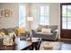 Comfortable living room with gray couches, decorative pillows, and stylish decor at 941 W Club Blvd, Durham, NC 27701