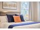 Relaxing bedroom featuring a plush bed with decorative pillows and a view of the window at 941 W Club Blvd, Durham, NC 27701
