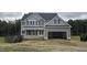 Two-story home featuring a spacious garage and classic gray siding at 98 Sanders Farm Drive, Smithfield, NC 27577