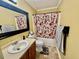 Bathroom featuring a floral shower curtain and framed mirror at 1000 Roundtable Ct, Knightdale, NC 27545