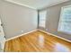 Bedroom with hardwood floors and natural light from two windows at 1000 Roundtable Ct, Knightdale, NC 27545
