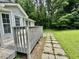 View of a wooden deck with a pathway leading to the lawn at 1000 Roundtable Ct, Knightdale, NC 27545