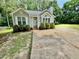 Charming single-story house with a well-manicured lawn and a long driveway at 1000 Roundtable Ct, Knightdale, NC 27545