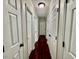 Hallway showcasing dark wood floors, white doors and trim at 1000 Roundtable Ct, Knightdale, NC 27545
