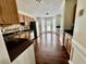 Spacious kitchen featuring wood floors, stainless steel appliances, and access to the sunroom at 1000 Roundtable Ct, Knightdale, NC 27545