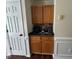 A kitchen nook features oak cabinets, dark countertops, and small appliances at 1000 Roundtable Ct, Knightdale, NC 27545
