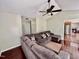 Cozy living room featuring a comfortable sectional sofa, ceiling fan, and hardwood floors at 1000 Roundtable Ct, Knightdale, NC 27545