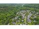A dense, green neighborhood is seen from above, featuring diverse architectural styles at 102 Newell St, Chapel Hill, NC 27516