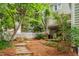 Exterior view of a quaint, green house with a fenced yard and a stone walkway at 102 Newell St, Chapel Hill, NC 27516