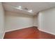 Unfinished basement area with sealed concrete block walls and dark wood floors at 102 Newell St, Chapel Hill, NC 27516
