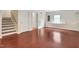 Finished basement space with hardwood floors, a staircase, and natural light from the window at 102 Newell St, Chapel Hill, NC 27516