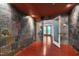 Finished basement has colorful slate tile accent walls, and doorway to outside patio at 102 Newell St, Chapel Hill, NC 27516