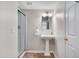 Well-lit bathroom with pedestal sink, glass-enclosed shower, and neutral color palette at 102 Newell St, Chapel Hill, NC 27516
