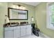 Stylish bathroom boasts double sinks with a black granite countertop and coordinated black fixtures at 102 Newell St, Chapel Hill, NC 27516