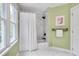 Modern bathroom with tiled walk-in shower, bathtub, and bright natural light from the large window at 102 Newell St, Chapel Hill, NC 27516