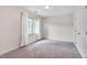 Bright bedroom featuring soft carpeting, a window with natural light, and a closet for storage at 102 Newell St, Chapel Hill, NC 27516