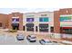 Two-story commercial building featuring colorful signage, covered walkways, and convenient parking at 102 Newell St, Chapel Hill, NC 27516