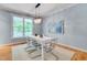 Bright dining room features hardwood floors, modern chandelier, and a large window with natural light at 102 Newell St, Chapel Hill, NC 27516