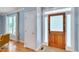 Bright foyer entrance featuring hardwood floors, natural light, and a wooden front door, creating a welcoming ambiance at 102 Newell St, Chapel Hill, NC 27516