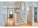 Welcoming foyer featuring a staircase, hardwood floors, natural light, and an open doorway at 102 Newell St, Chapel Hill, NC 27516