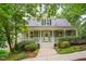 Charming two-story home with a welcoming front porch and landscaped yard, perfect for outdoor relaxation and curb appeal at 102 Newell St, Chapel Hill, NC 27516