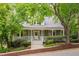 Charming home exterior featuring a front porch, well-manicured landscaping, and mature trees at 102 Newell St, Chapel Hill, NC 27516