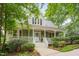 Inviting home featuring a classic porch and well-maintained landscaping, creating a warm and welcoming curb appeal at 102 Newell St, Chapel Hill, NC 27516