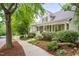 Beautiful home exterior featuring a front porch, well-manicured landscaping, and mature trees at 102 Newell St, Chapel Hill, NC 27516