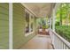 Relaxing front porch area showcasing a comfortable swing and serene outdoor ambiance, perfect for enjoying quiet moments at 102 Newell St, Chapel Hill, NC 27516