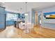Eat-in kitchen with blue cabinets, stainless steel appliances, a kitchen island, and hardwood floors at 102 Newell St, Chapel Hill, NC 27516