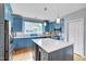 Kitchen with blue cabinets, stainless steel appliances, white countertops, and hardwood floors at 102 Newell St, Chapel Hill, NC 27516