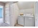 Bright laundry room features a washer, dryer, and ample storage space with overhead rack at 102 Newell St, Chapel Hill, NC 27516