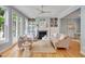 Elegant living room featuring hardwood floors, a cozy fireplace, and French doors, perfect for relaxation and entertaining at 102 Newell St, Chapel Hill, NC 27516