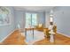 Bright living room with hardwood floors, a stylish desk, and comfortable yellow seating, creating a cheerful and functional space at 102 Newell St, Chapel Hill, NC 27516