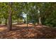 Community playground with swings, slides, and climbing structures set in mulched area at 102 Newell St, Chapel Hill, NC 27516