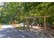 Beautifully landscaped community playground with climbing features and a slide at 102 Newell St, Chapel Hill, NC 27516