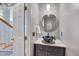 Stylish powder room with a modern sink, decorative mirror, and elegant lighting fixtures at 102 Newell St, Chapel Hill, NC 27516