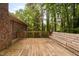 Large wooden deck featuring built-in bench seating with a backyard and brick house at 103 Tiara Ct, Garner, NC 27529