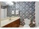 Bathroom with floral wallpaper, vanity, and shower at 103 Tiara Ct, Garner, NC 27529