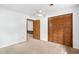 A bedroom with a double-door closet and an open doorway creates a sense of space and accessibility at 103 Tiara Ct, Garner, NC 27529
