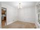 Clean and elegant dining room featuring neutral carpet and chandelier at 103 Tiara Ct, Garner, NC 27529