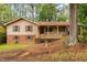 Charming two-story home with tan siding, brown shutters, brick accents, and a cozy front porch at 103 Tiara Ct, Garner, NC 27529