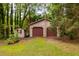 Spacious two-car garage with additional storage shed, set in a lush green yard at 103 Tiara Ct, Garner, NC 27529