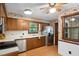 Retro kitchen with stainless steel refrigerator and wooden cabinetry with stainless dishwasher at 103 Tiara Ct, Garner, NC 27529
