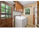 Utility room with washer, dryer, and cabinet storage space at 103 Tiara Ct, Garner, NC 27529