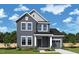 Charming two-story home with gray siding, white trim, and a well-manicured front lawn at 104 Restful Pt, Fuquay Varina, NC 27526