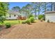 View of the backyard featuring a deck and landscaping at 110 Phyllis Dr, Benson, NC 27504
