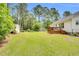 A spacious backyard with a shed and wooden deck at 110 Phyllis Dr, Benson, NC 27504