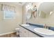 Bathroom featuring a double sink vanity and decorative mirrors at 110 Phyllis Dr, Benson, NC 27504